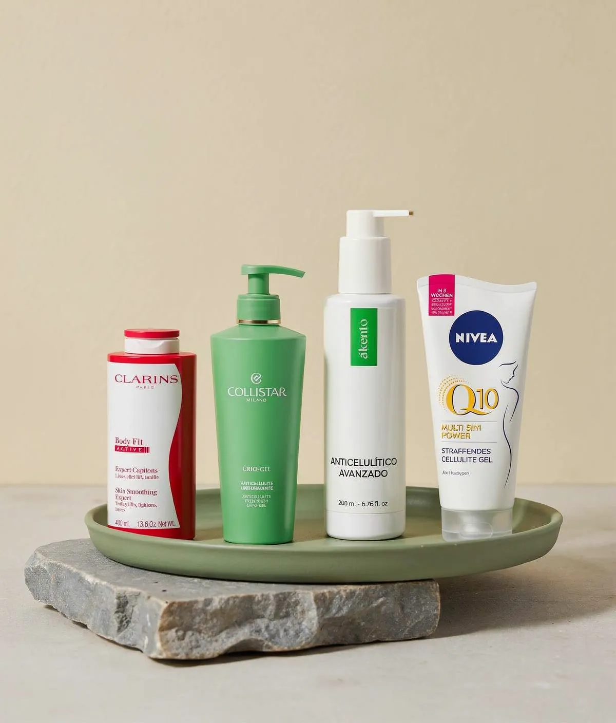 Comparativa editorial de geles anticelulíticos, con el envase de Akento destacado en primer plano sobre una superficie crema, verde salvia y azul grisáceo